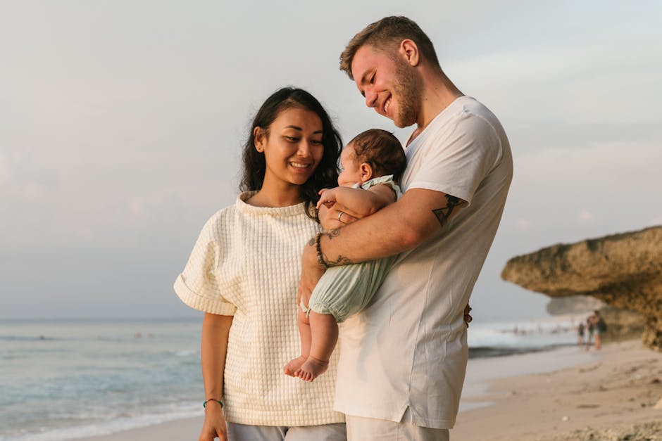 A joyful family enjoying a serene beach sunset with their baby. Perfect depiction of love.