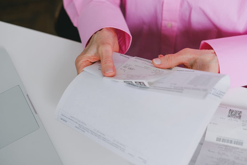 Business person handling paper receipts, meticulously organized.
