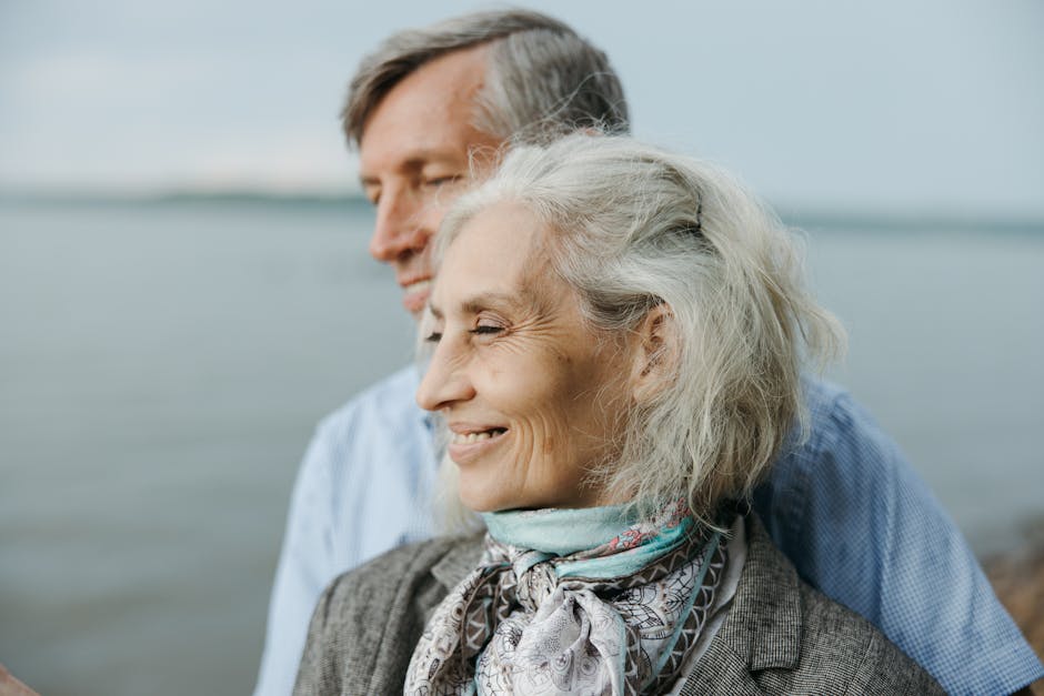 Senior couple sharing a romantic moment by the lake, showcasing love and togetherness.