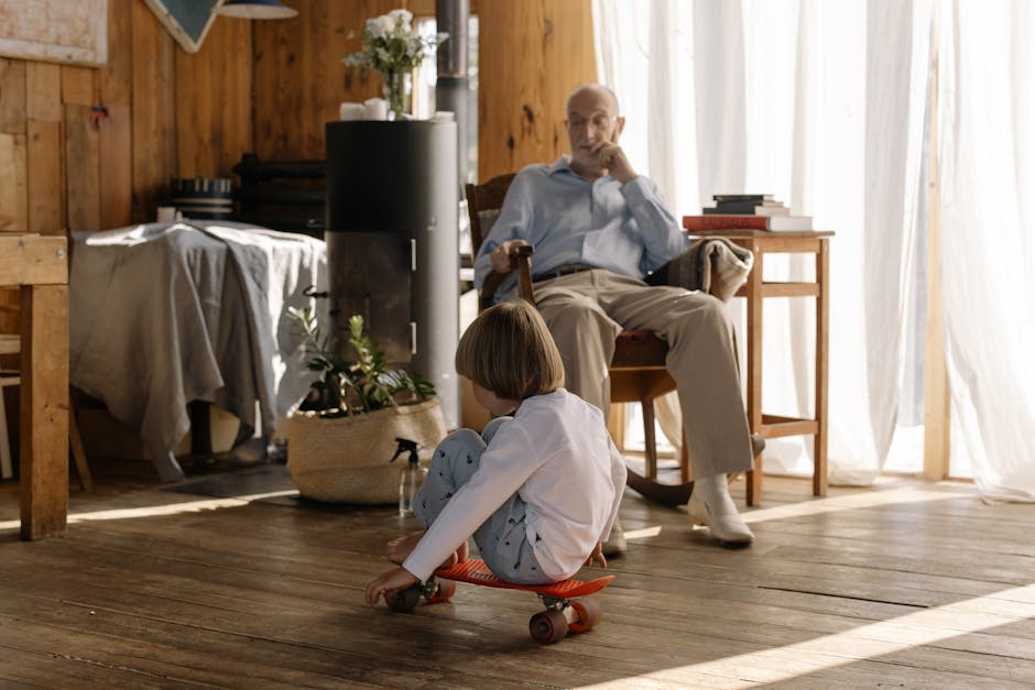 Child riding skateboard inside a cozy wooden room with an elderly man sitting and watching.
