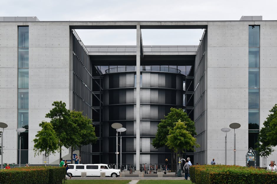 Contemporary architecture of a urban building facade with street and greenery in Berlin, Germany.