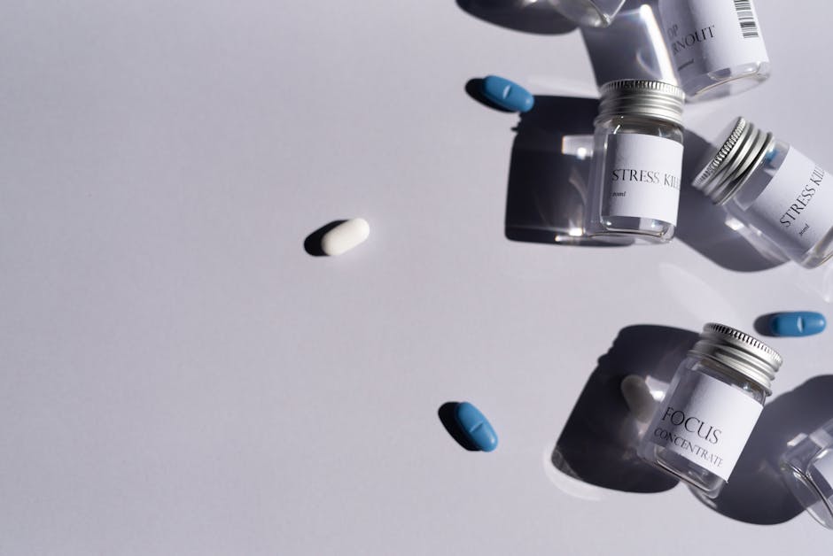 Flat lay of medicine bottles and pills on a white background, perfect for healthcare themes.