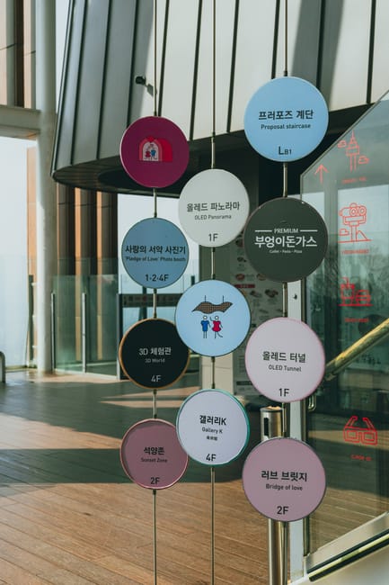 Colorful signage at a Seoul landmark, showcasing various attractions and features.