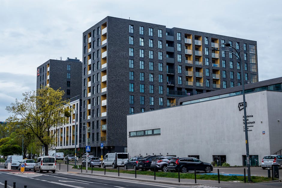 Contemporary architecture of residential buildings in an urban setting, featuring modern design and street elements.
