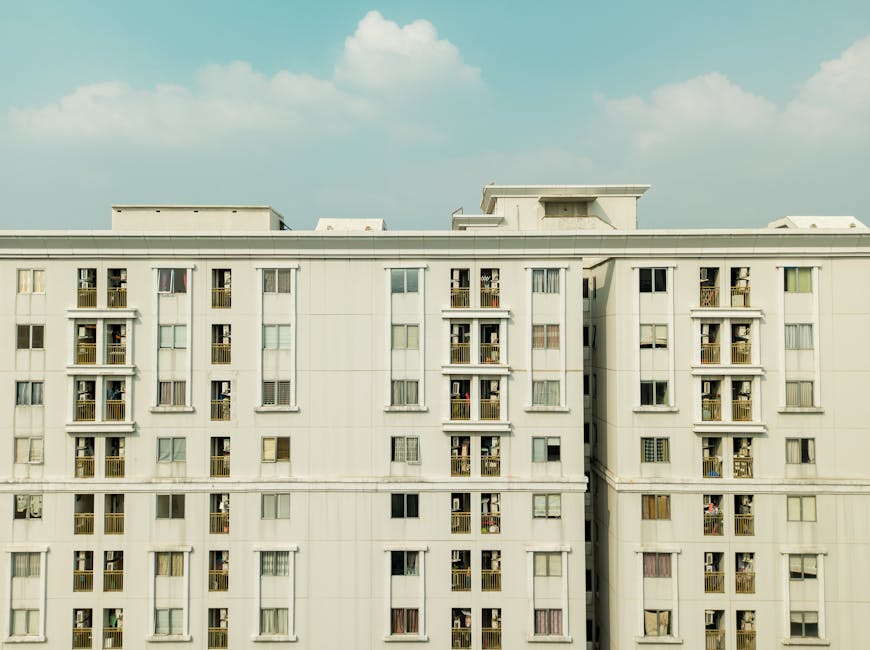 Detailed exterior view of a high-rise building with balconies and windows.
