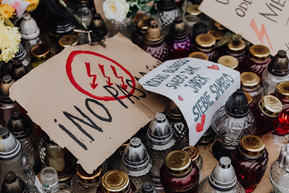 A dynamic scene of a Polish demonstration with candles and protest signs advocating change.