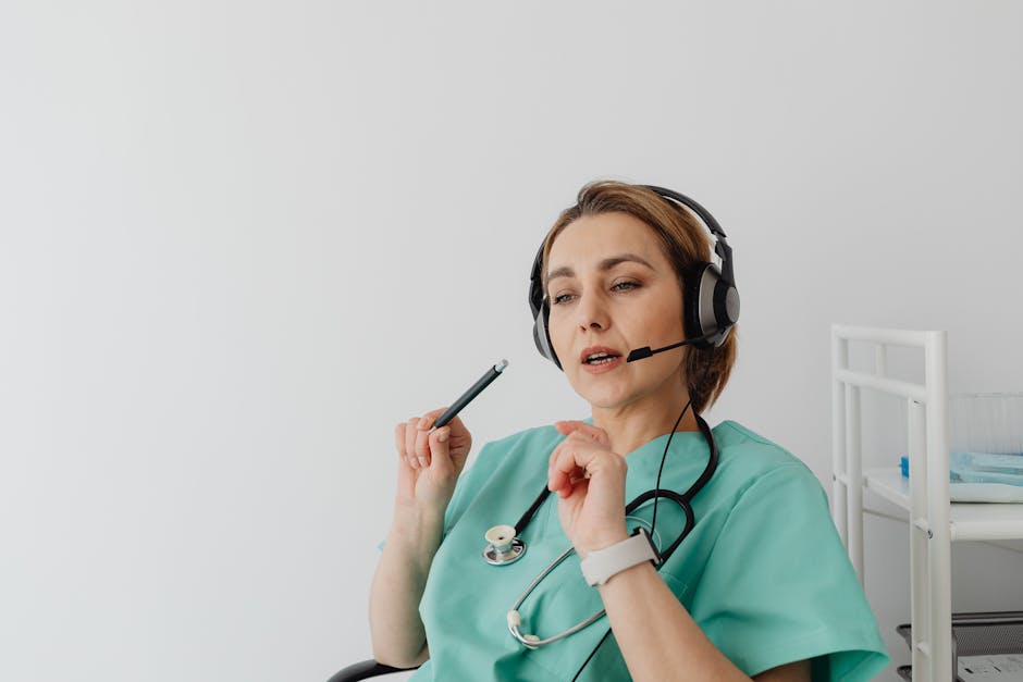 Doctor wearing headset and scrubs engages in an online consultation