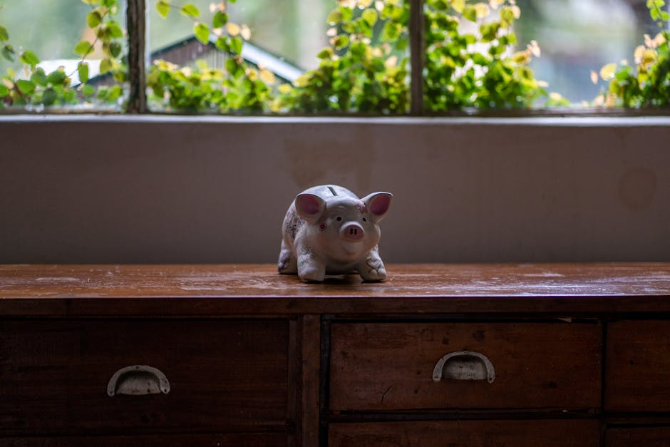 Vintage piggy bank ornament atop a classic wooden furniture piece indoors.