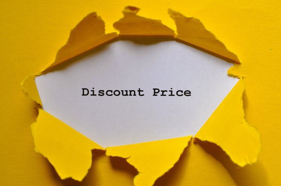 Eye-catching image of torn yellow paper revealing the words 'Discount Price.'