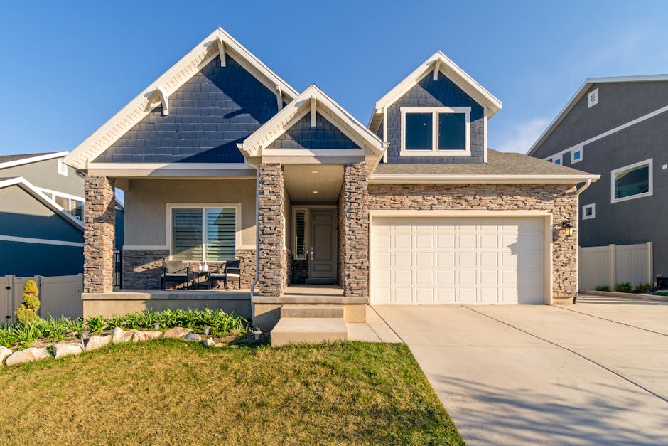 A charming modern suburban home with a stone facade and a neatly maintained lawn.