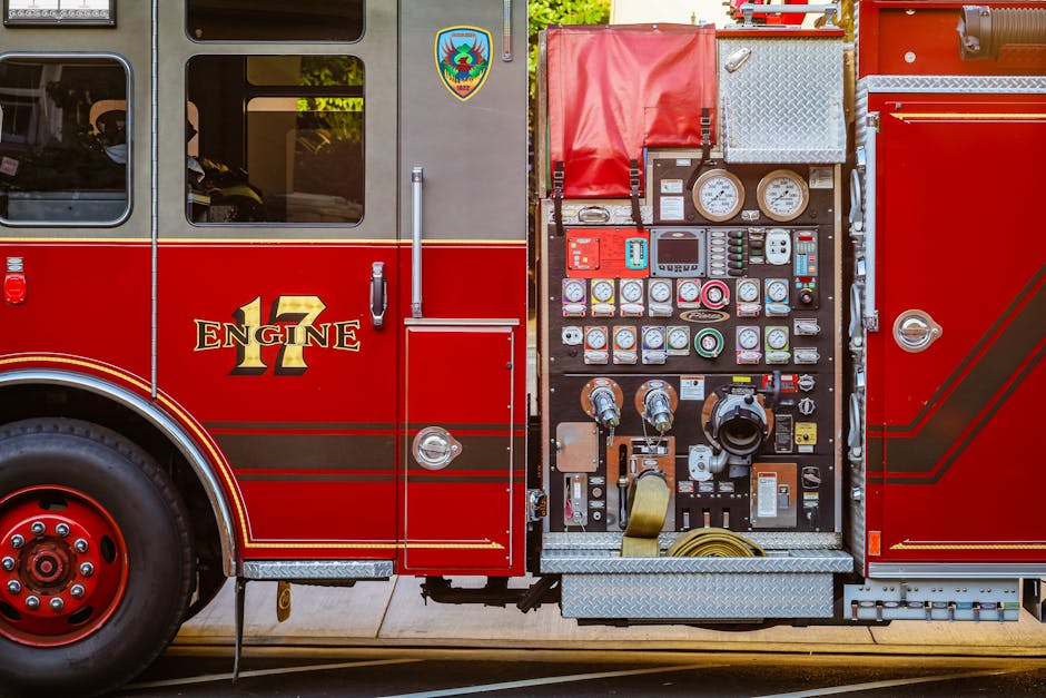 Detailed view of a fire truck's control panel and side compartment with equipment.