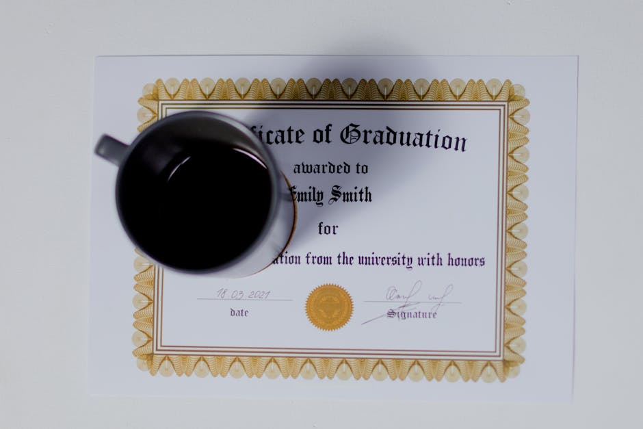 Graduation certificate with a coffee cup placed on top in a flat lay style