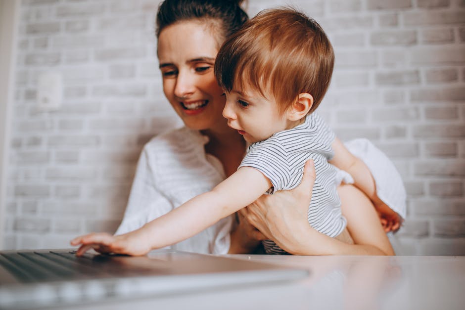 A loving mother and child enjoying time together at home, using a laptop.