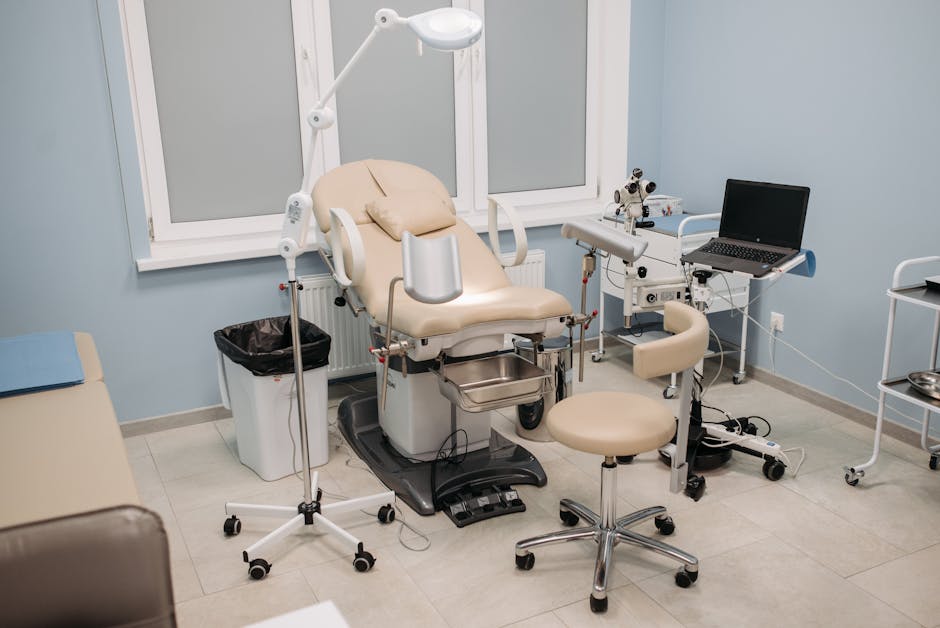 Clean and well-equipped medical office featuring an examination chair and various medical tools.