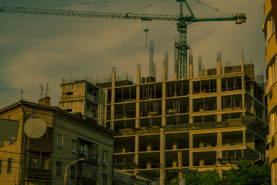 A crane over a modern building under construction in Dnipro, Ukraine.