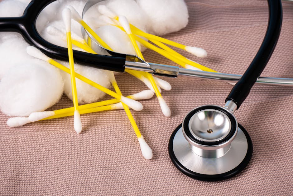 Detailed image of cotton swabs and a stethoscope on a textile surface, ideal for healthcare themes.