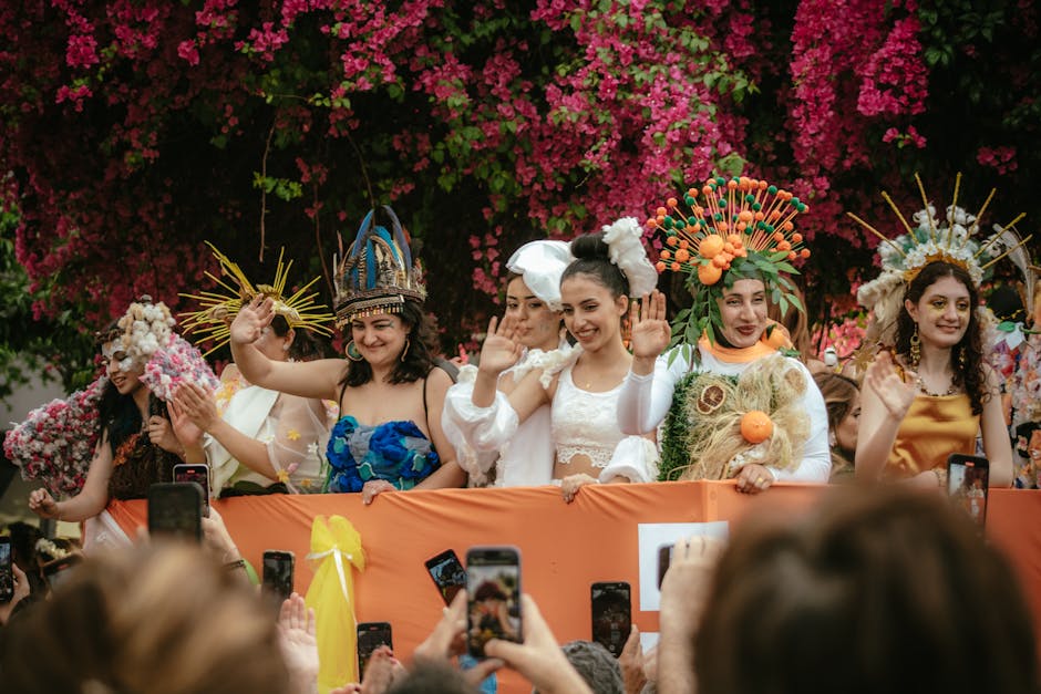 Women in vibrant, traditional costumes wave during a festive parade in Adana, Türkiye.