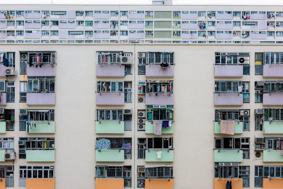 Multicolored urban apartment building with balconies and windows, showcasing city living.