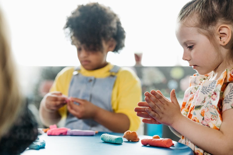Young children playing with colorful clay indoors, enhancing creativity and learning.