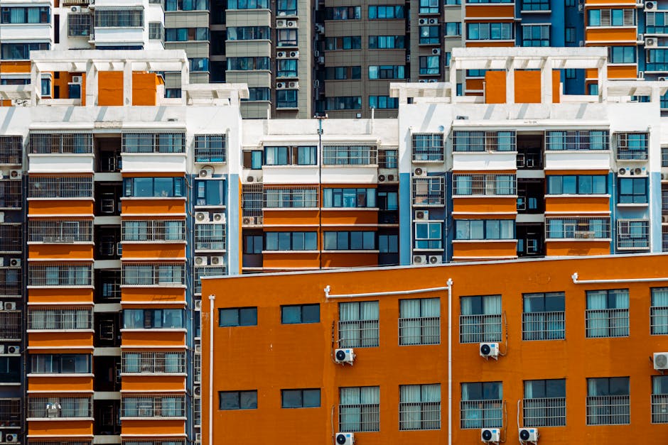 Close-up view of vibrant apartment facades with air conditioning units in a city setting.