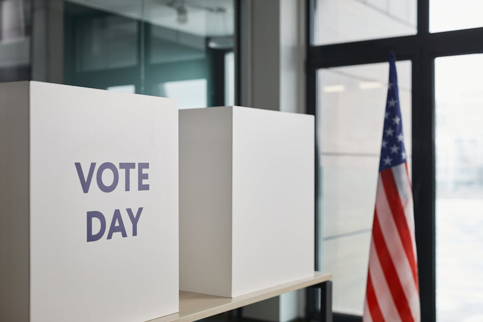 Voting booth setup with American flag, symbolizing election day.