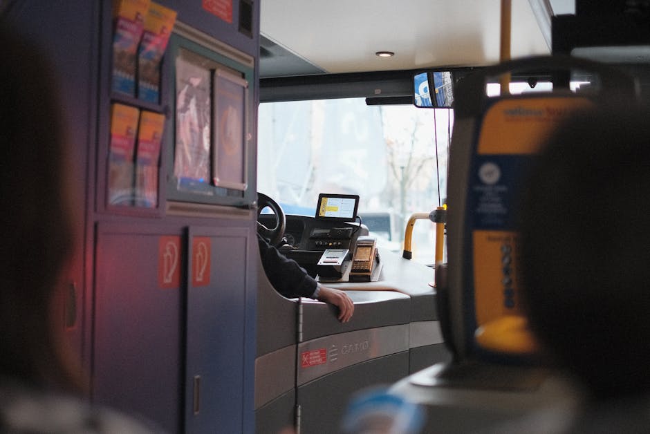 A modern bus interior showcasing the driver's area during daylight hours.