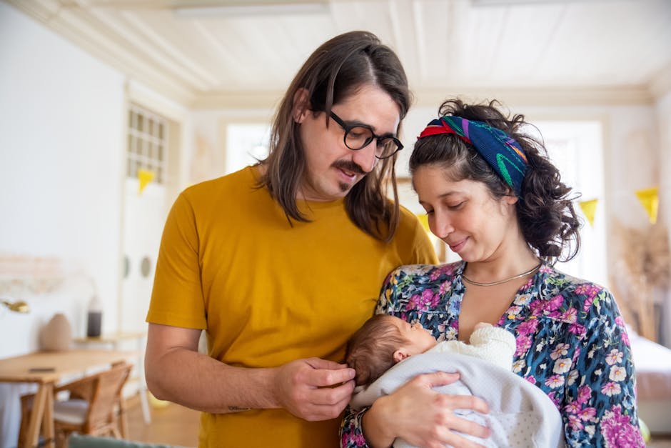 A tender family moment with parents holding their newborn baby indoors.