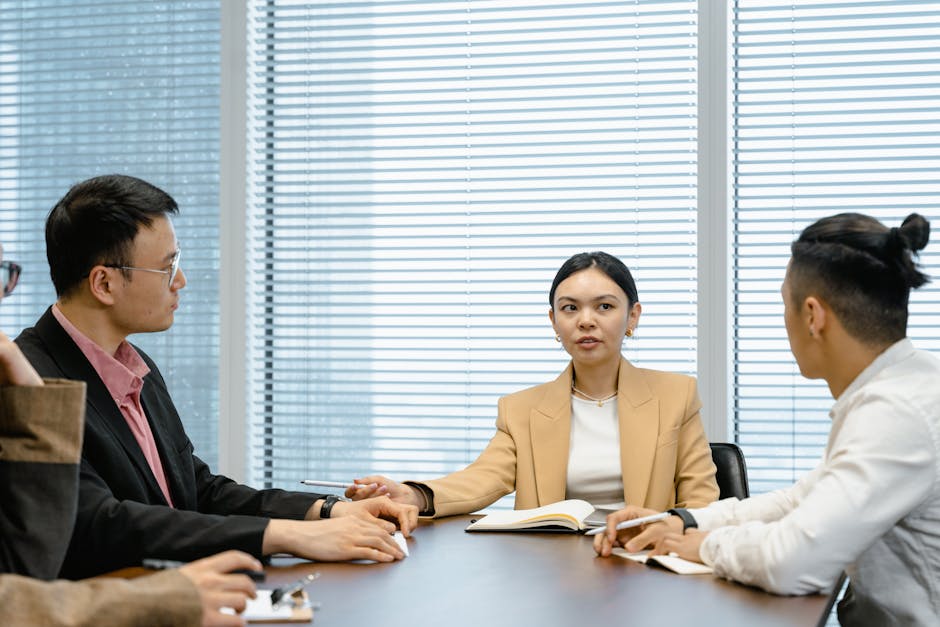 A diverse group of business professionals having a meeting around a conference table.