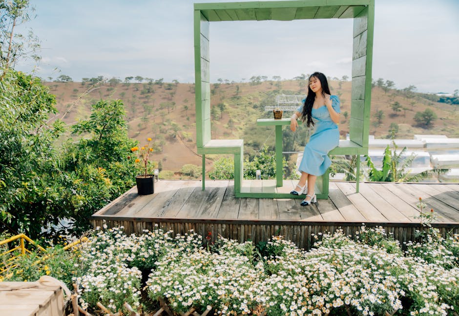 Young woman enjoying a sunny day at a scenic café in Dalat, Vietnam.