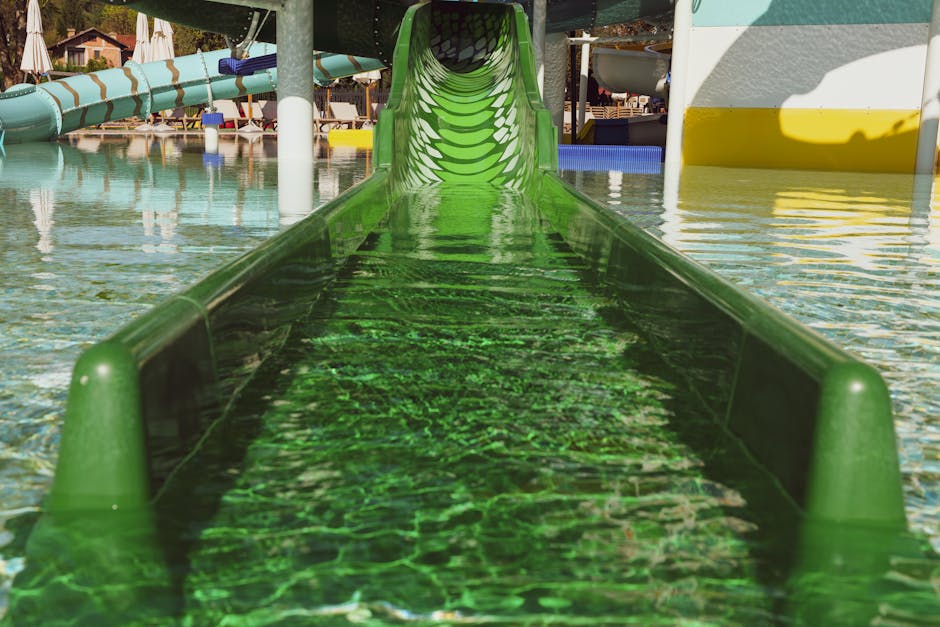 Green water slide in a colorful aquapark during a sunny summer day in Stubičke Toplice, Croatia.