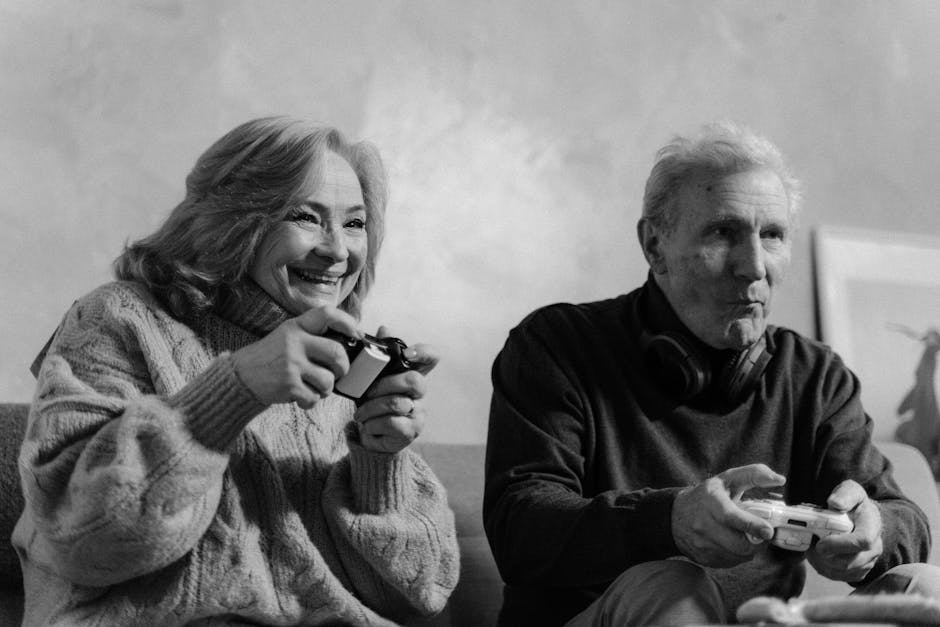 Elderly couple joyfully playing video games together in a cozy home setting.