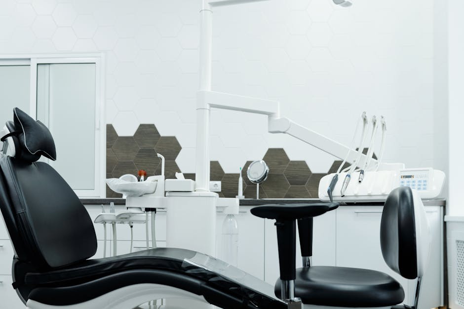 Clean and organized dental office featuring a modern dental chair and equipment.