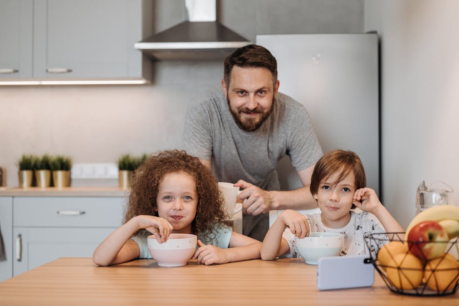 Father and children enjoying breakfast together in a cozy kitchen setting.