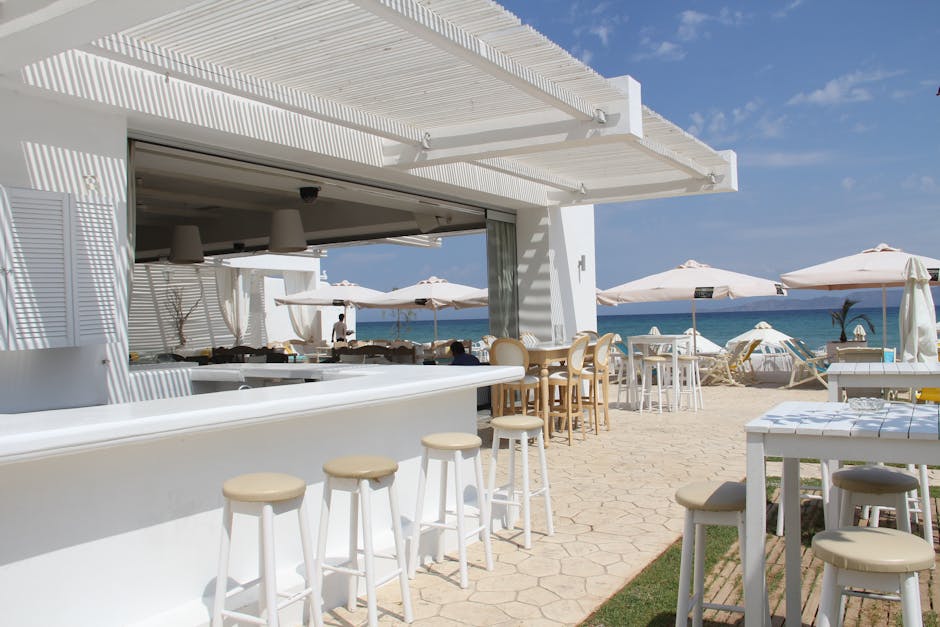 Elegant outdoor bar and restaurant by the ocean, perfect for a luxury vacation.