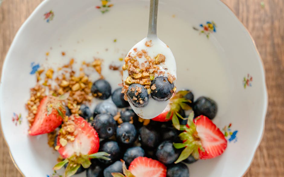 Close-up of a healthy yogurt bowl with fresh fruits and granola, perfect for a nutritious breakfast.