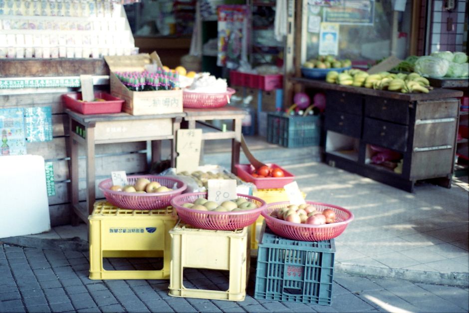A traditional fruit stand in Taiwan selling fresh produce including apples and bananas.