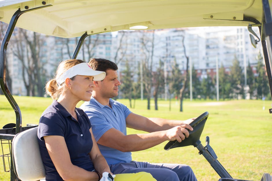 A man and woman in a golf cart on a sunny day, enjoying outdoor leisure time.