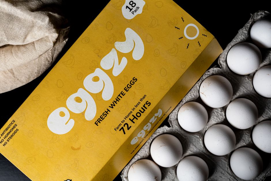 High-quality fresh white eggs in branded carton packaging. Perfect for food stock images.