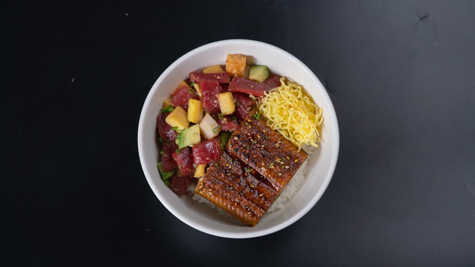 A vibrant tuna poke bowl with unagi and fresh vegetables, perfect for sushi lovers.