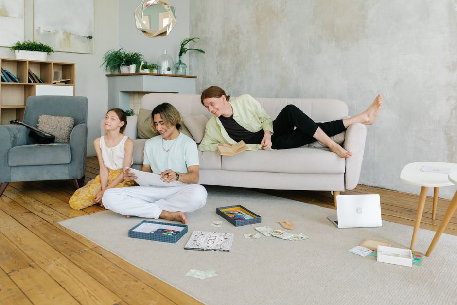 A cheerful family enjoys a leisure day indoors, playing and relaxing together.