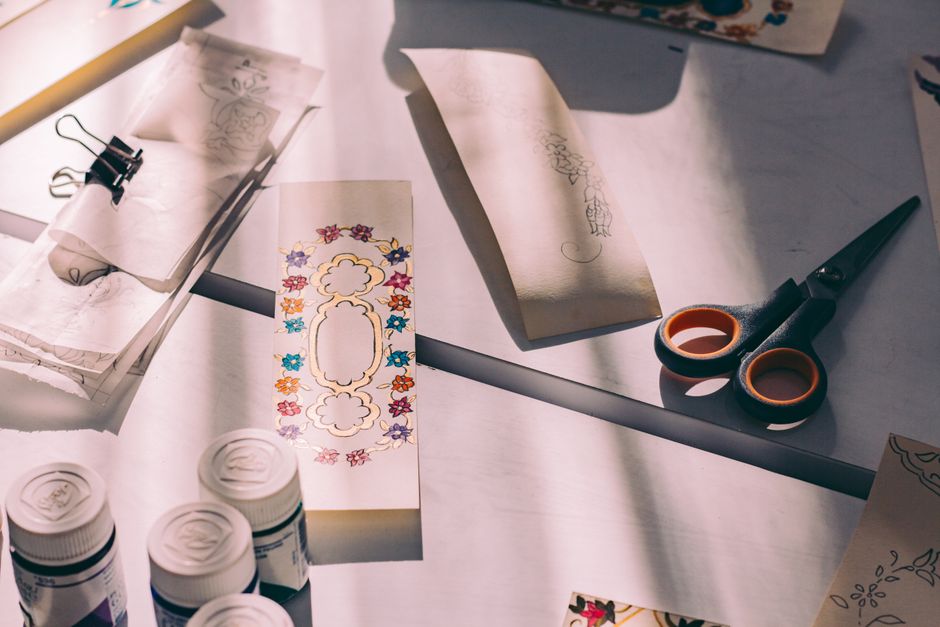 Colorful craft materials and scissors in a sunlit workspace, perfect for artistic projects.