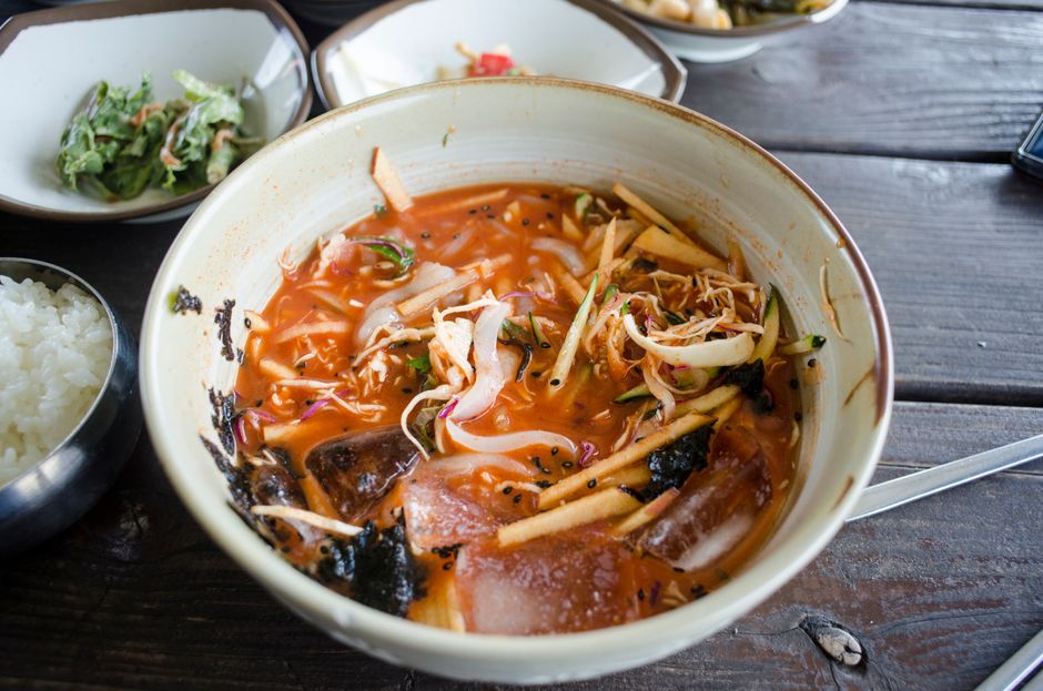 Delicious Korean noodle soup with spicy broth, vegetables, and seaweed.