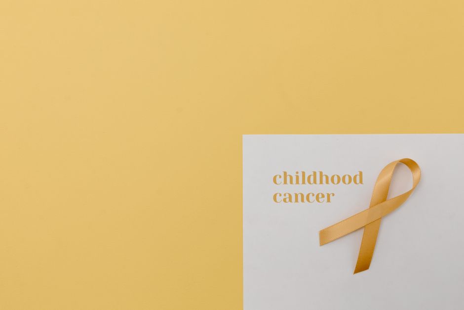 Yellow ribbon symbolizing childhood cancer awareness with ample copy space.