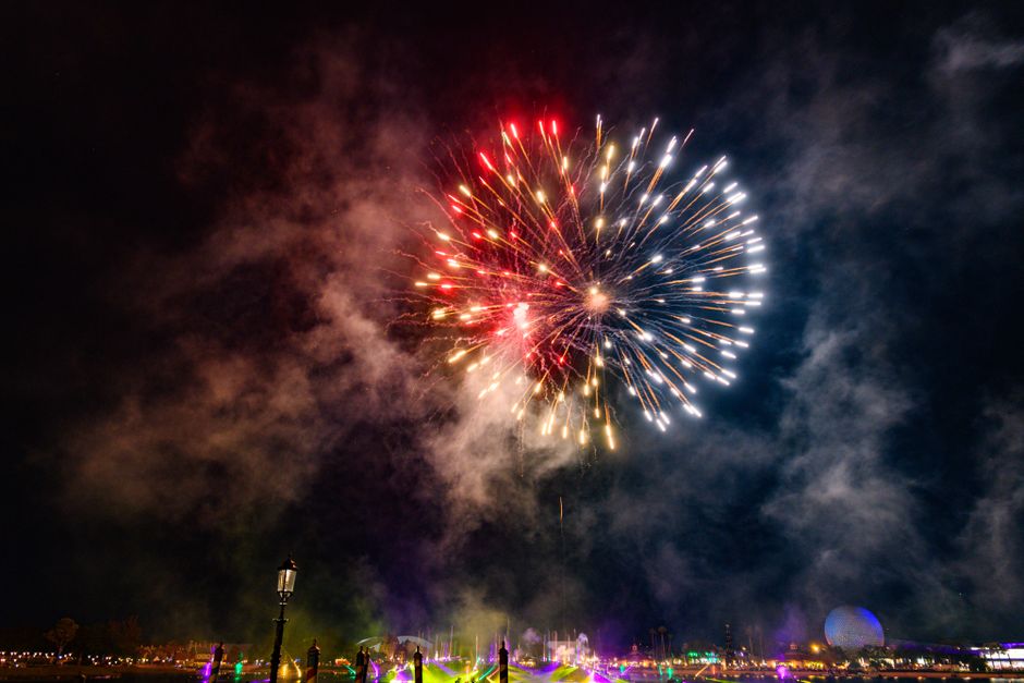 Colorful fireworks light up the night sky over a theme park in Florida, USA.