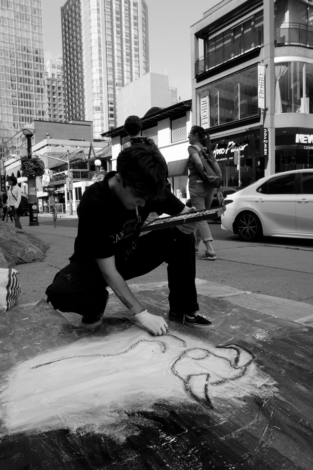 Louis painting on the street during the Yorkville Murals (YVM) Festival 2025