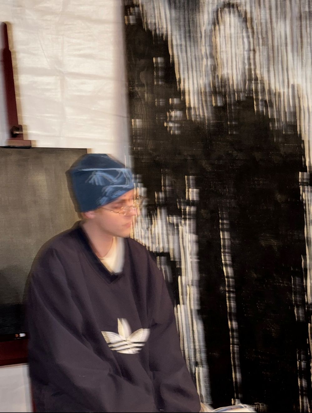 Louis standing in front of 'Untitled (Death)' against the wall of his third studio.