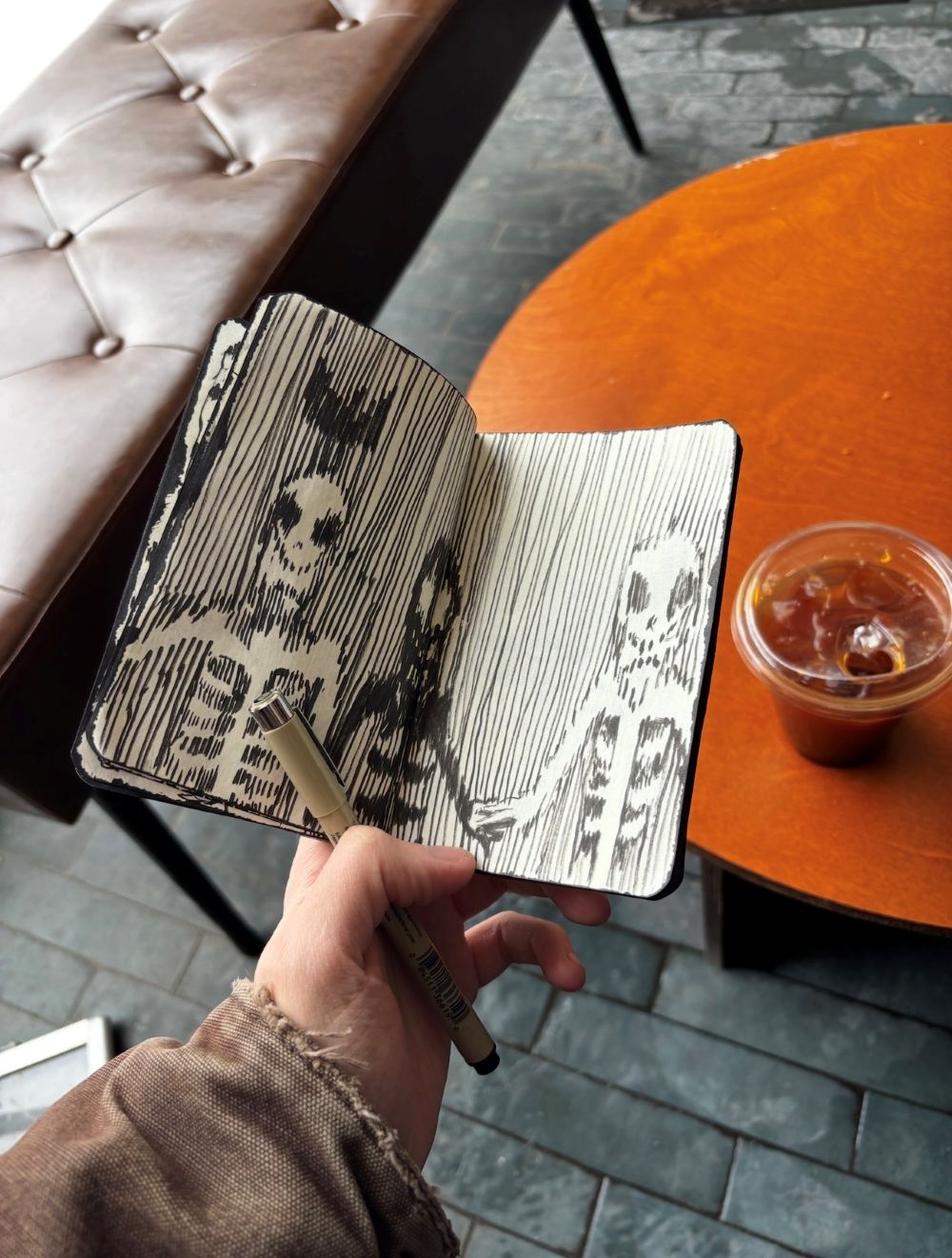 Louis sketching in his 'Black Book' at Rooms Cafe on Baldwin Street, Toronto.