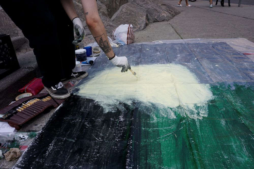 Louis painting on the street during the Yorkville Murals (YVM) Festival 2025