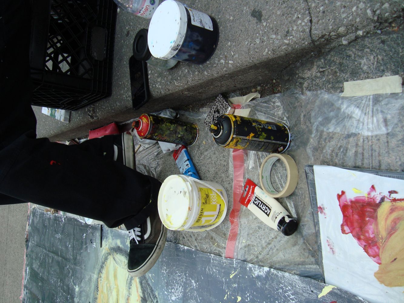 Louis painting on the street during the Yorkville Murals (YVM) Festival 2025