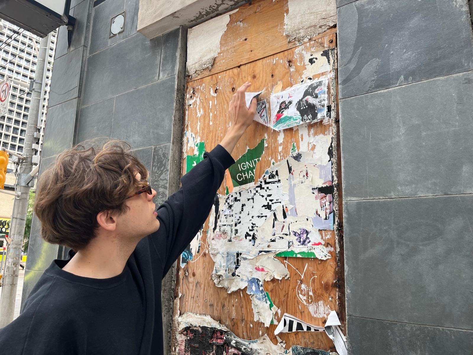 Louis painting on the street during the Yorkville Murals (YVM) Festival 2025